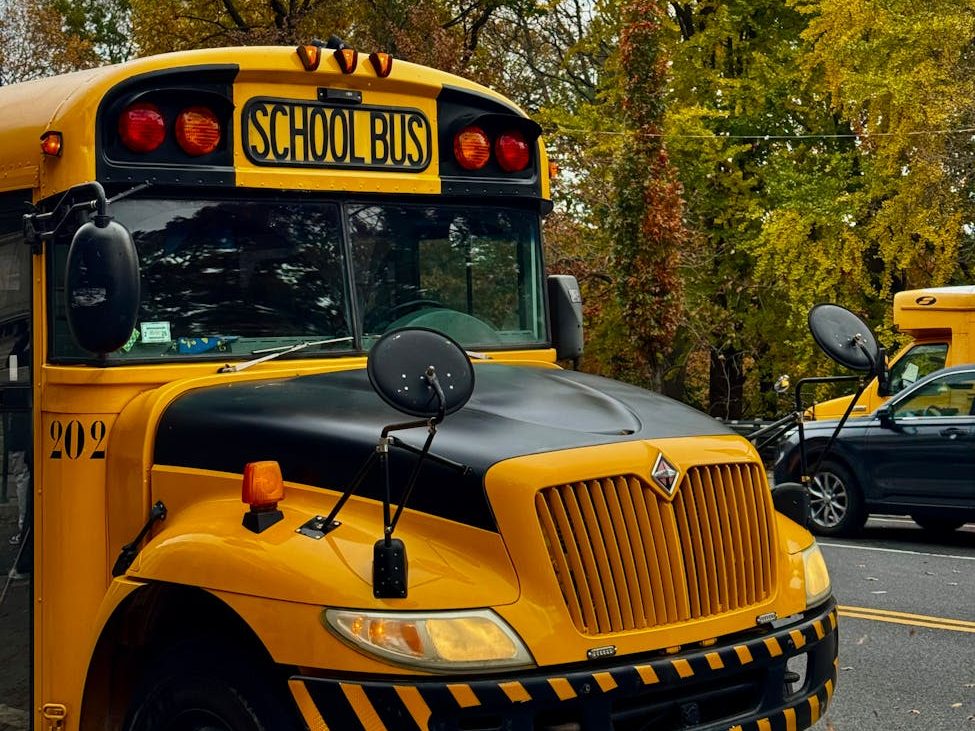 yellow school bus in autumn nyc street scene